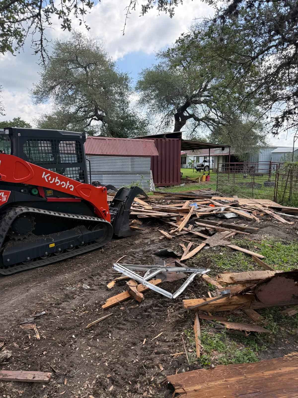 Skid steer clearing demolition debris